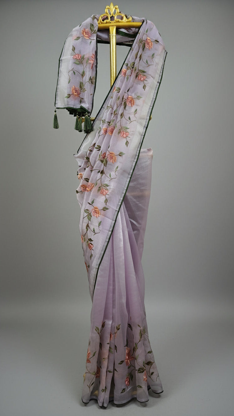 Embroidered saree with floral patterns on a white background