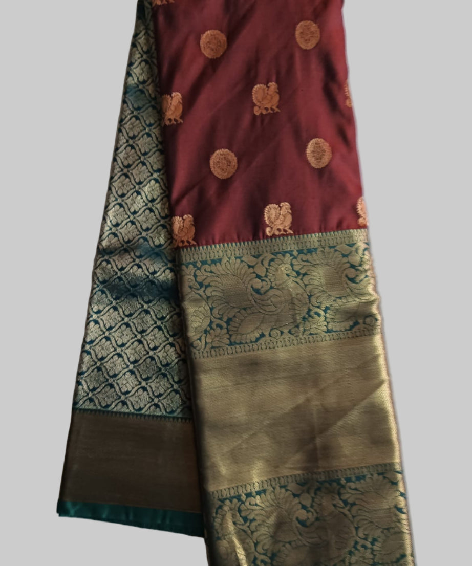 Traditional saree with maroon and green patterns on a white background