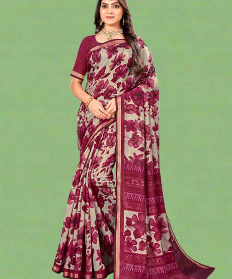 Woman wearing a shell silk saree with floral patterns in a decorated indoor setting.