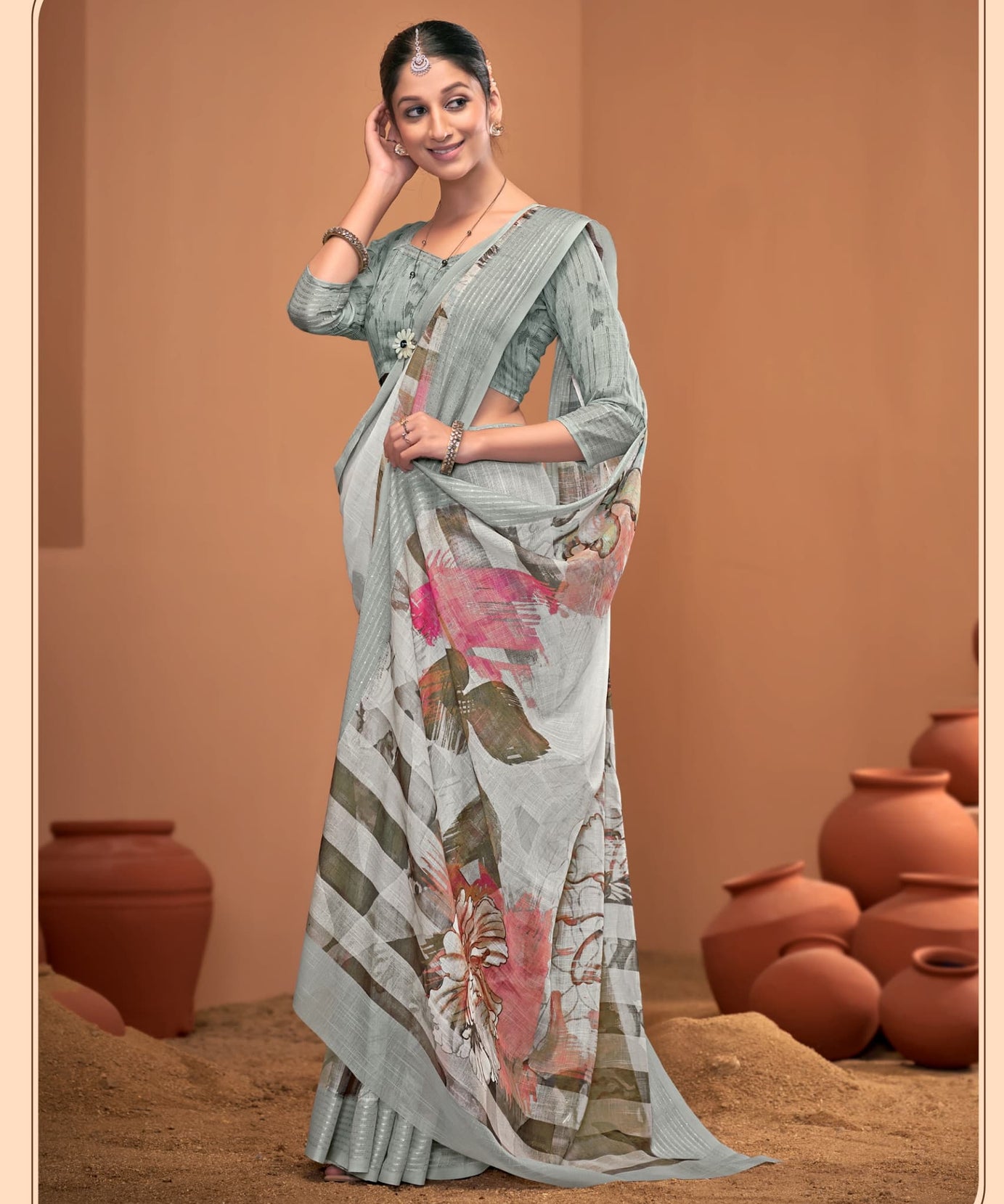 Woman wearing a floral saree with a neutral background